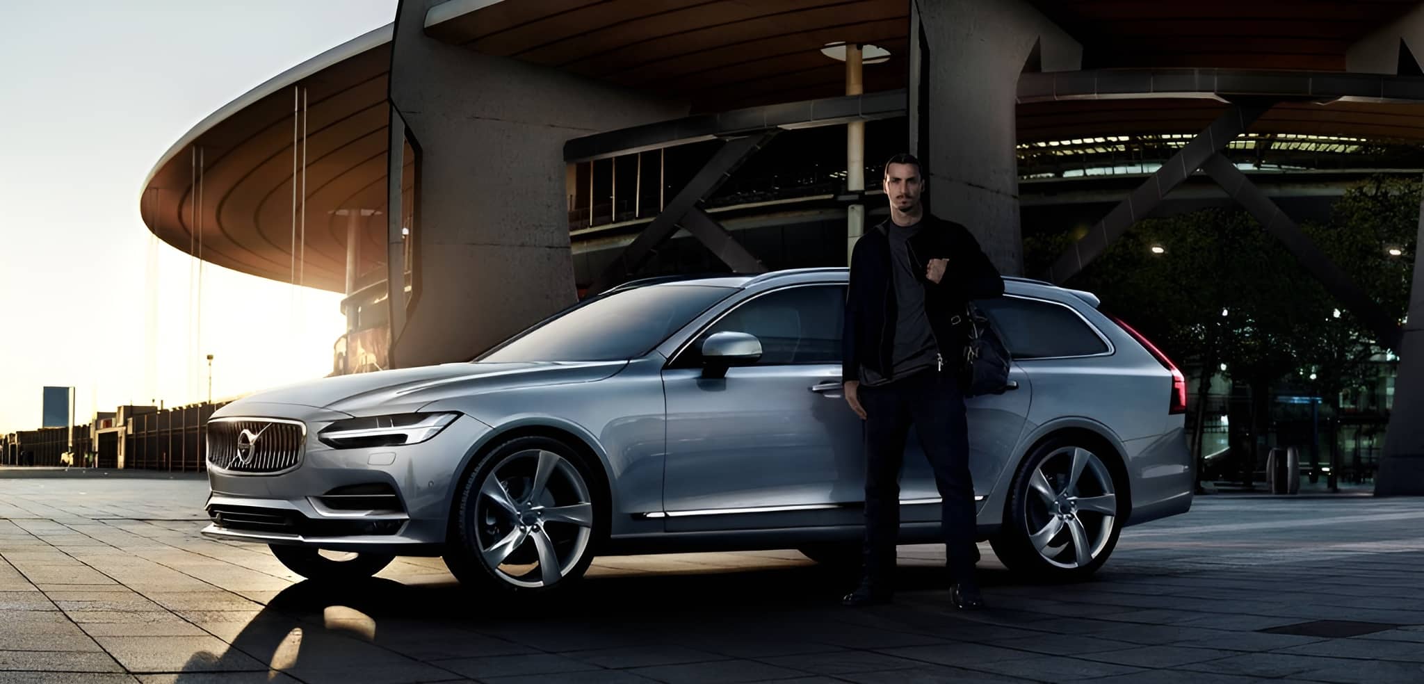 Zlatan Ibrahimovic standing beside a silver Volvo car — a Bornaballer BAB™ lifestyle inspiration image symbolizing leadership, success, and the sustainable premium football‑and‑business mindset shaped by Swedish legends.